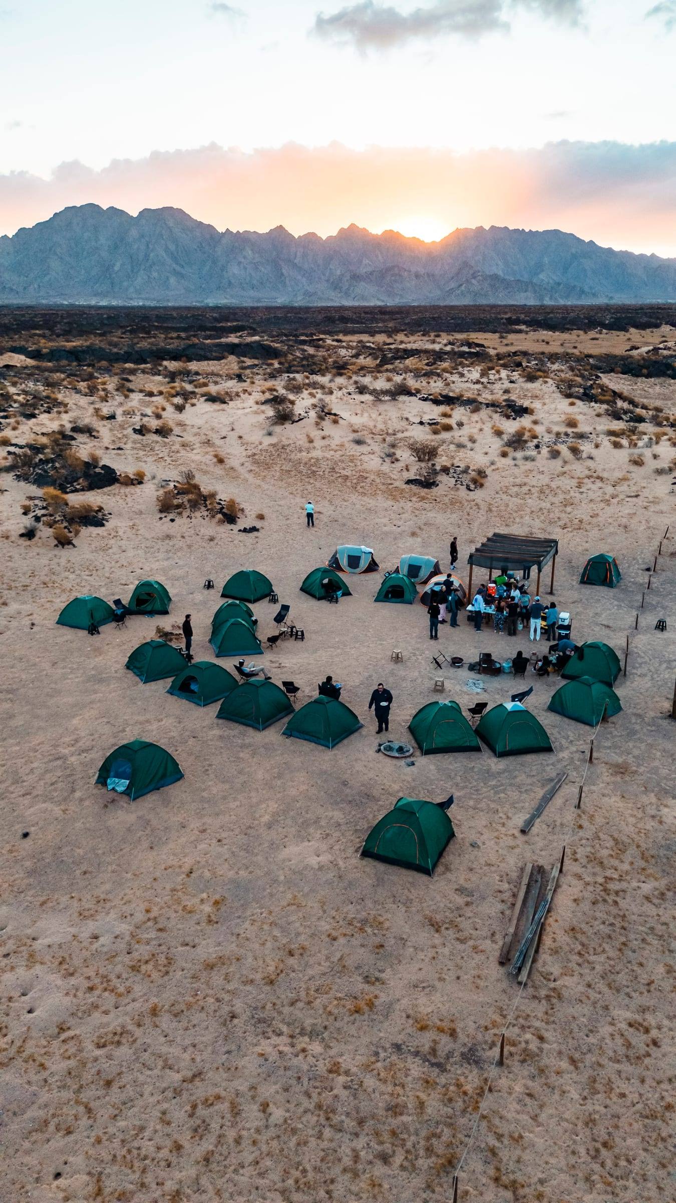 A camp of green tents seen from the air